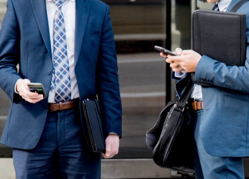 two-business-men-using-their-smart-phones-no-faces-wearing-suits-carrying-leather-briefcase-satchels_t20_g8EVoa (1)
